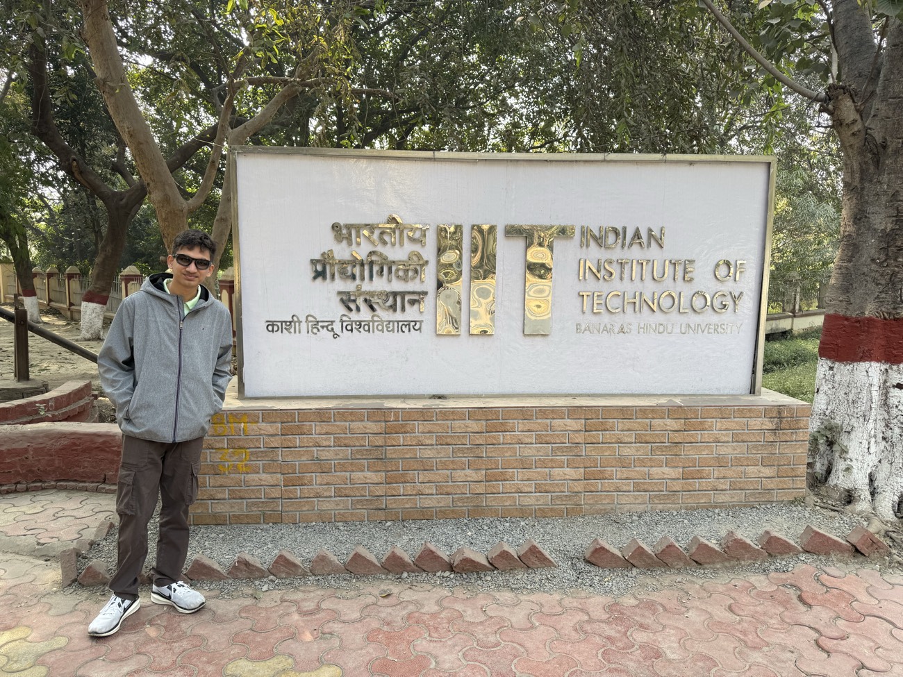 Hemish standing beside the Indian Institute of Technology (BHU) Varanasi campus sign.